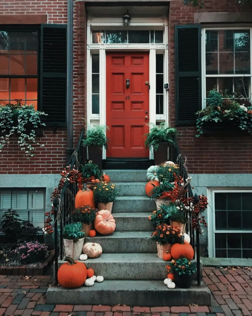 Pumpkins on Stairs in Front of A Door